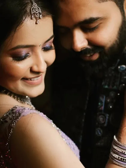 A tender embrace that highlights the bride's beautiful mehendi and engagement ring. Her joyful smile and the couple's closeness make this a perfect candid shot, full of warmth and happiness.