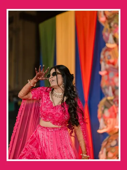 The bride owns the dance floor. This shot captures her vibrant energy and fun-loving spirit during her Sangeet performance, a perfect memory of the night's celebrations.