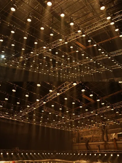 A wide shot of the 150-Parcan grid, creating dramatic shafts of light through haze for the Mahindra commercial.