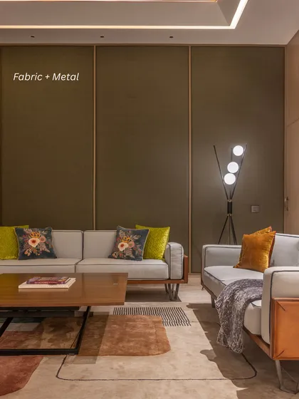 Fabric + Metal: In this lounge, a fabric-paneled wall with sleek metal inlays provides a soft yet structured backdrop, proving that luxury can be both soft and strong.