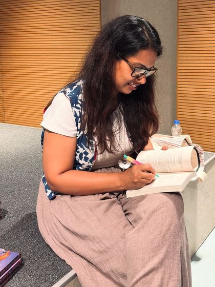 A candid moment of an author signing books after a session. These personal interactions are what make our events so special for both authors and readers.