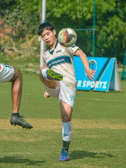 A young player expertly controls the ball on his thigh, a display of the technical skill and flair we encourage at our academy.