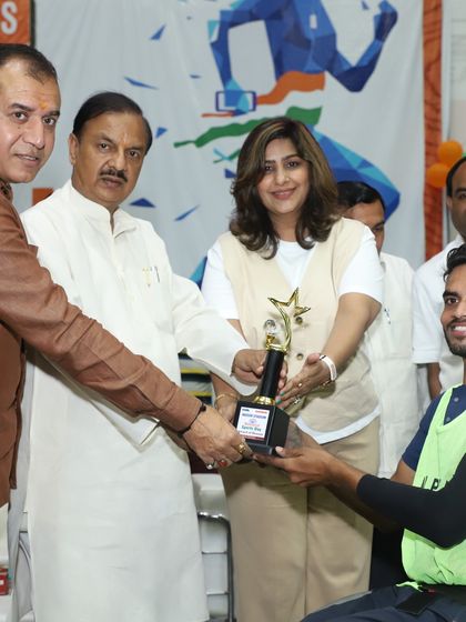 Honoring a wheelchair basketball medalist on National Sports Day, alongside esteemed guests like Member of Parliament Dr. Mahesh Sharma. We celebrate the achievements of all athletes and their dedication to sport.