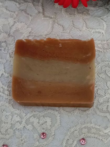 A single bar of Harmony soap, showcasing its natural color from clays and botanicals.