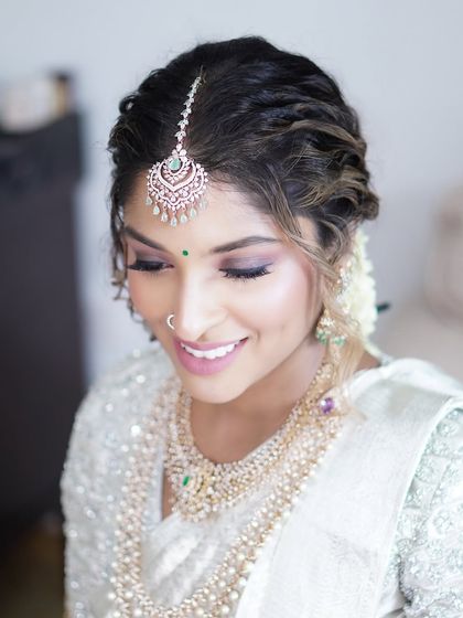 A joyful, smiling portrait of Reshma. This image captures the essence of a happy bride, with makeup that enhances her glow and looks beautiful from every angle.