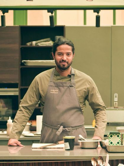 A moment of readiness before service begins. I stand proud in my workspace, ready to create an exceptional meal for my guests.