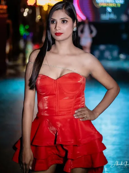 A model looking radiant in a red corset-style dress at the TomTom Skybar event, a perfect example of capturing vibrant party wear.
