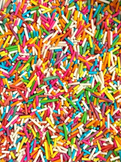 A close-up of the rainbow sprinkles I use. They add a pop of colour and a fun crunch to my birthday cakes.