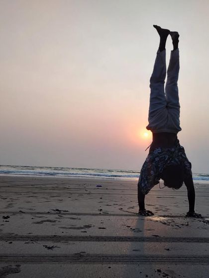 Adho Mukha Vrksasana (Handstand) at sunset on the beach in Goa. This inversion builds incredible upper body and core strength, improves balance, and stretches the abdominal muscles.