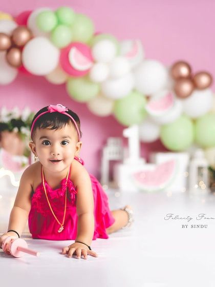 A full view of the adorable watermelon-themed first birthday setup. The bright colors are so cheerful and fun.