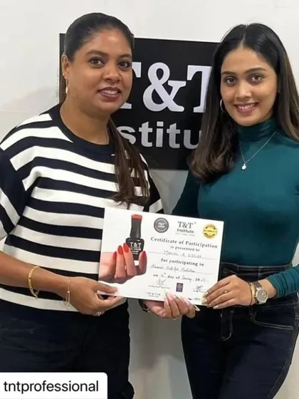 A moment of achievement. This student receives her certificate after a successful masterclass, ready to apply her new skills.