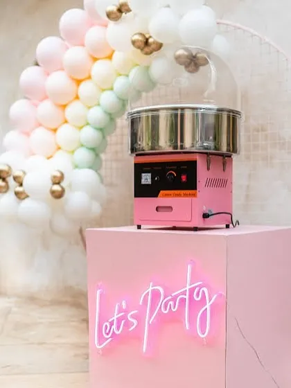 Let's Party! This chic and modern setup with a neon sign shows how our cotton candy station can be styled for a trendy, upscale event.