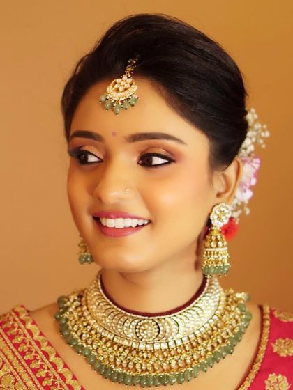 We transitioned Nony to a glamorous North Indian bridal look by adding glitter accents and emphasizing her eyes and cheeks. The result was a stunning transformation that radiated elegance and grace.