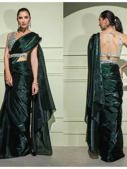 The front and back view of the emerald green organza saree, showing the deep back of the blouse and the flow of the metallic fabric.
