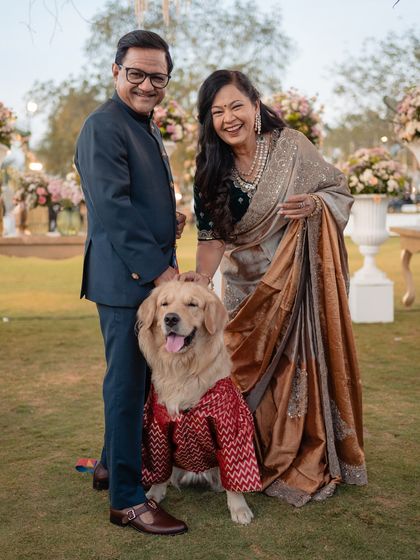 The best family portraits include every member. We even helped style the family's golden retriever in a custom bandhani jacket to match the festive theme.