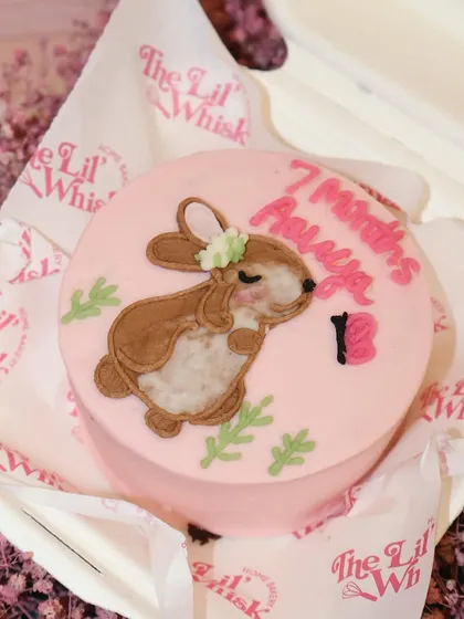 Celebrating seven sweet months with this adorable bunny-themed bento cake. The soft pink frosting and cute illustration are perfect for monthly milestones.