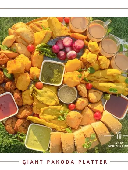 The ultimate comfort food experience. Our Giant Pakoda Platter offers a wide assortment of freshly fried pakodas with various chutneys and chai.
