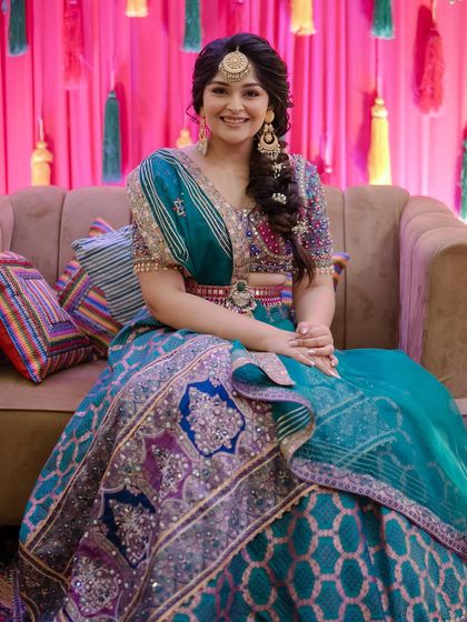 The full look of the bride with her festive side braid, perfect for a vibrant Mehendi ceremony.