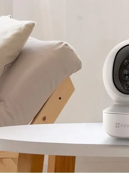 The EZVIZ smart home camera is a popular choice for indoor monitoring. Placed on a table in a living room, its sleek design blends into your home decor while providing features like motion tracking and two-way talk.
