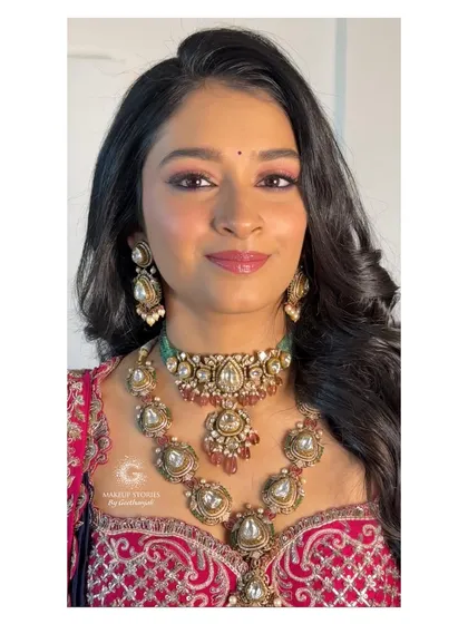 A direct portrait of Mithila's reception look. The focus is on her bright, happy eyes and the intricate details of her polki jewelry, all tied together with flawless makeup.