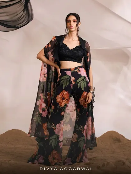 A stunning floral printed co-ord set, featuring a cape, bralette, and flared pants for a complete, fashion-forward look.