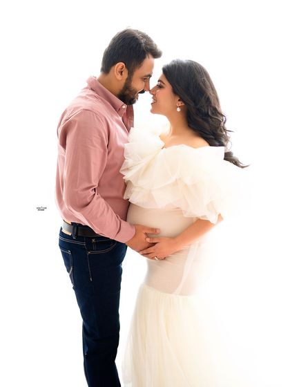 A simple and sweet high-key portrait. The focus is all on their loving gaze and the anticipation of their new arrival.