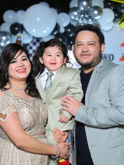 Another shot of the family at the birthday bash, with the little boy looking dapper in his suit.