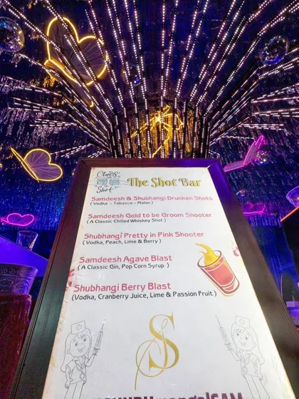 A custom shot bar menu for the Sangeet, with creative drink names that are personalized for the bride and groom.