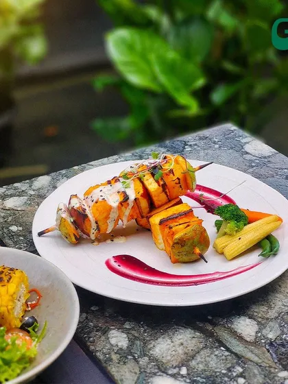 Our cottage cheese skewers are a vegetarian delight. Marinated and grilled to perfection, they are served with a side of salad and a beautiful plate presentation.
