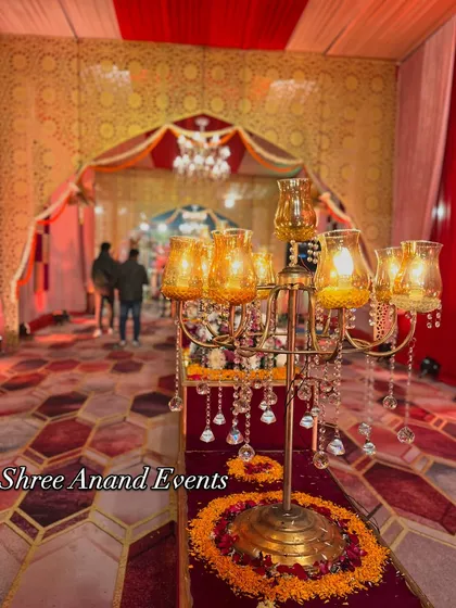 A close-up of a crystal and brass candelabra, a key element in our lighting design that adds a touch of classic elegance to event walkways.