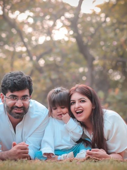 A moment of laughter and whispers. We encourage families to interact naturally to capture these genuine expressions.