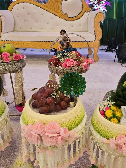 Another view of the beautiful fruit and floral stands, adding a touch of class and freshness to the event decor.