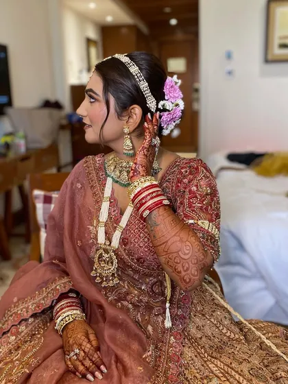 Another angle showing the beautiful details of Simran's hair and makeup. The fresh flowers in her bun add a touch of romance to the look.