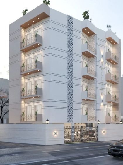 A different angle of the facade with jaali work, highlighting how the design looks from the street. The combination of modern form and traditional patterns is central to our design philosophy.