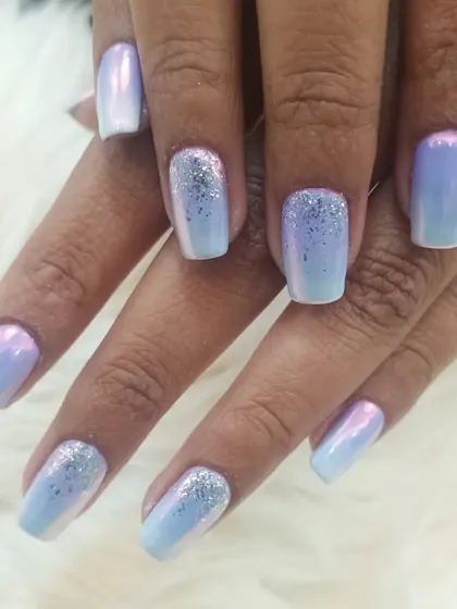 A close-up of the iridescent chrome and glitter manicure. This view captures the beautiful color shift of the chrome powder and the sparkle of the glitter.