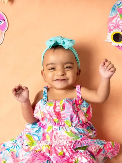 A happy smile from our little beachgoer. The bright colors and fun props of this summer theme make for such cheerful and lively photos.
