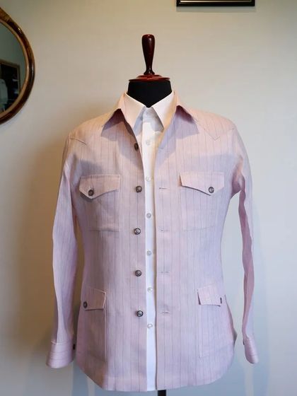 A stroke of sophistication. Our custom-sized, premium linen overshirt in a charming baby pink shade, adorned with subtle stripes.