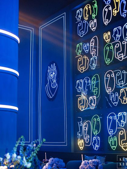 A detail of the neon light wall inspired by Picasso. Each face, bent from glowing tubes, captures a different mood, turning the wall into a dynamic piece of art that reflects the emotional depth of Picasso's work.