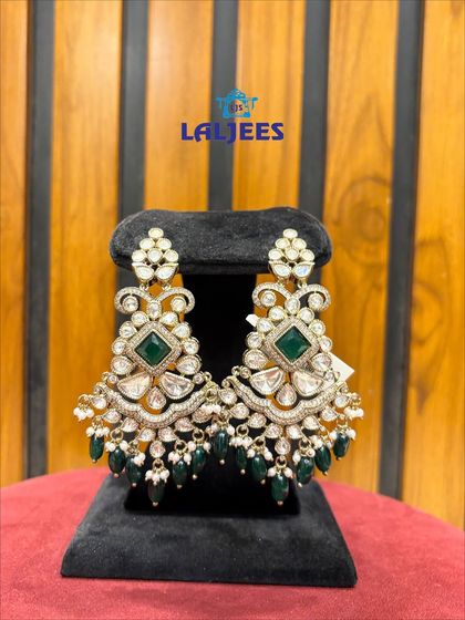 These green and white kundan earrings are designed to make a statement. They are perfect for a bride who wants a bold look.