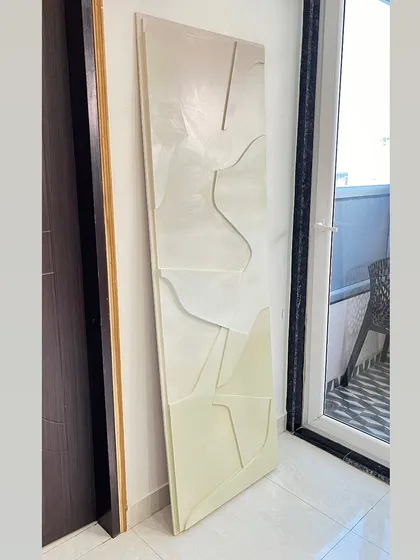 A 67" x 22" textured piece created for a client in Hyderabad. The subtle, tone-on-tone design uses raised lines to create a sense of gentle movement.