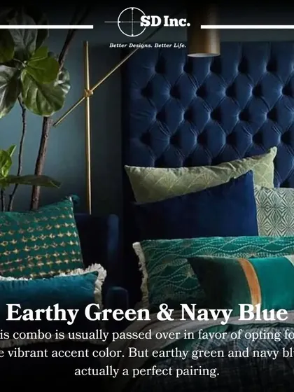 An example of an earthy green and navy blue color combination in a bedroom. The deep blue tufted headboard is complemented by various green accent pillows, creating a rich and sophisticated look.
