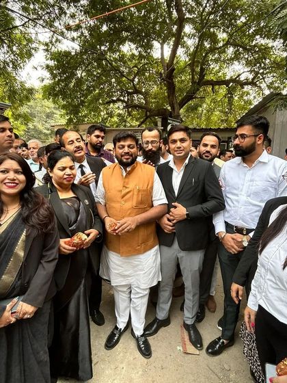 With supporters and colleagues, showing solidarity with important social causes.