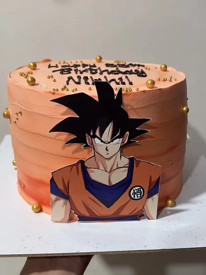 A still shot of the 1.5kg Goku-themed cake, showing the clean lines and vibrant orange frosting.