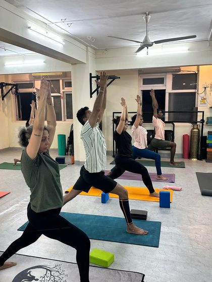 We believe movement is the best medicine for the body. Our classes are not just about achieving poses but about celebrating what our bodies can do, like in this Virabhadrasana I (Warrior I).