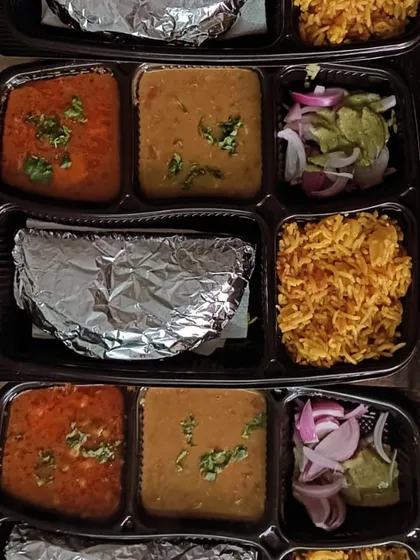 A vibrant thali featuring Matar Paneer, dal, and colorful vegetable pulao. This is a great option when you want something more festive than plain rice.