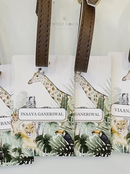 Close-up of the personalized safari luggage tags. I can customize these with each guest's name for a truly bespoke party favor.