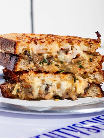 An up-close shot of the Cheesy Mushroom Melt, highlighting the rich, melted cheese and mushroom filling.