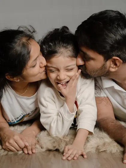 Sometimes the best portraits are the unposed ones. This candid shot from a family session in my studio captures the pure joy and affection between parents and their child, a perfect memory of their bond.