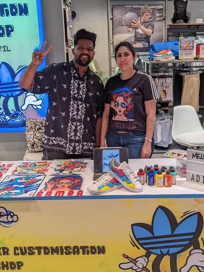 Our team behind the desk at the Adidas Viviana Mall event, surrounded by our art supplies and design examples. We come fully equipped to handle any creative request.
