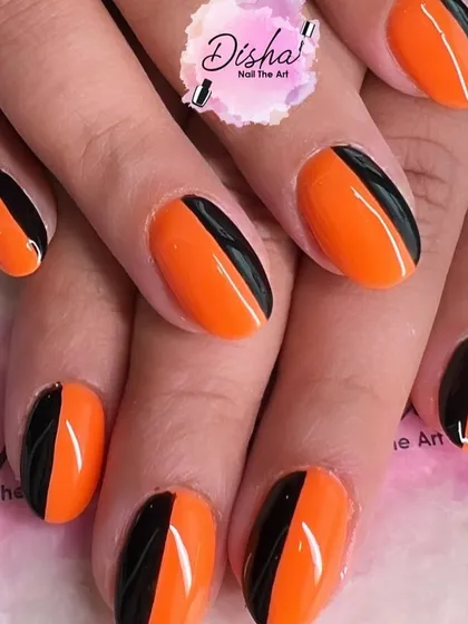 A bold and graphic look. This design combines vibrant orange and classic black in a clean, color-blocked style for a modern and edgy manicure.